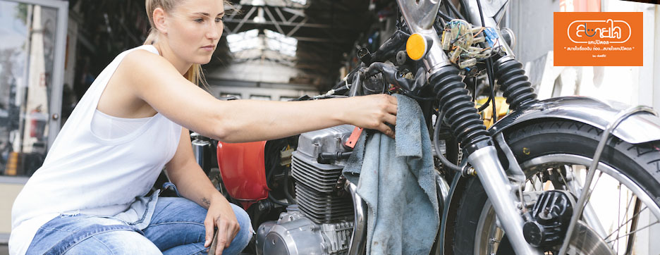 the lady cleans motorbike